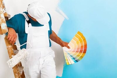 Painter in Koregaon applying interior wall paint